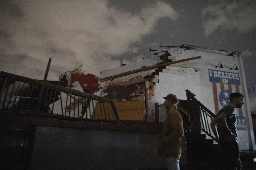 People stand outside the Basement East music venue in East Nashville after it was destroyed by ...