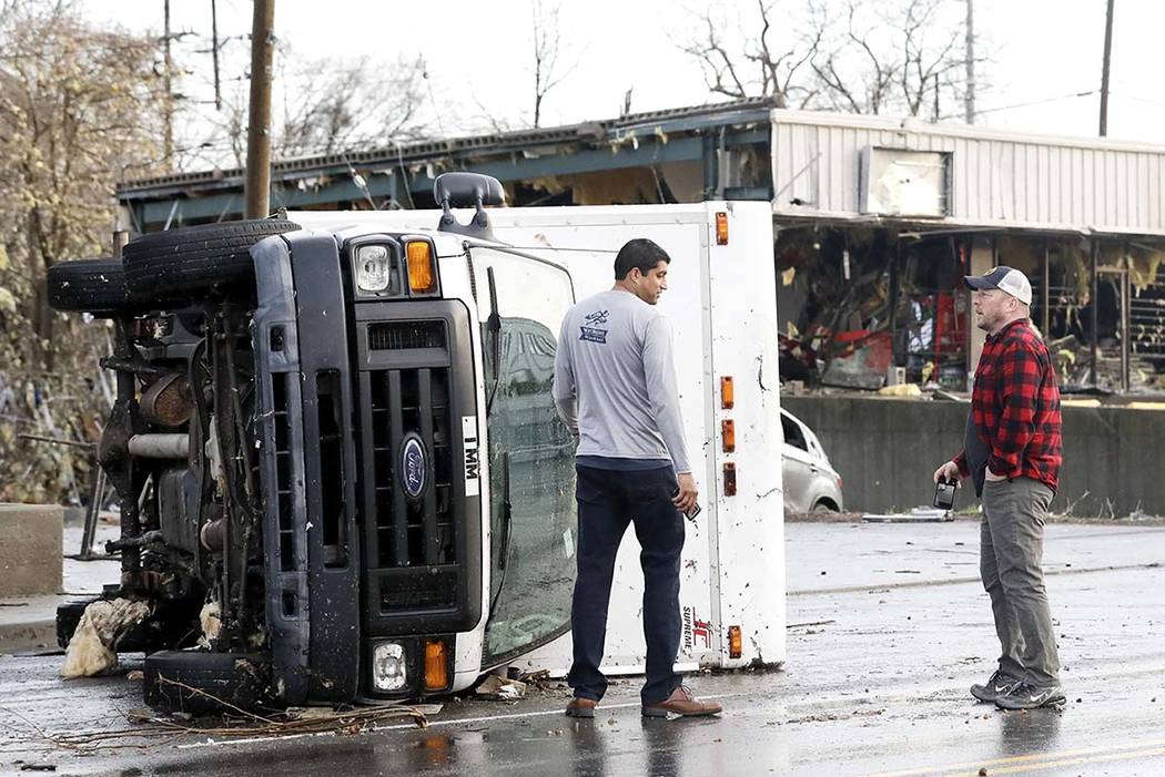 A overturned truck sits in a street in an area damaged by storms Tuesday, March 3, 2020, in Nas ...