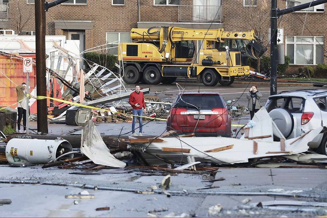 People look over storm damage Tuesday, March 3, 2020, in Nashville, Tenn. Tornadoes ripped acro ...