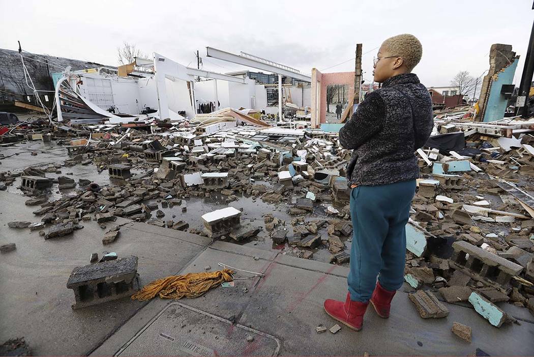 Faith Patton looks over buildings destroyed by storms Tuesday, March 3, 2020, in Nashville, Ten ...