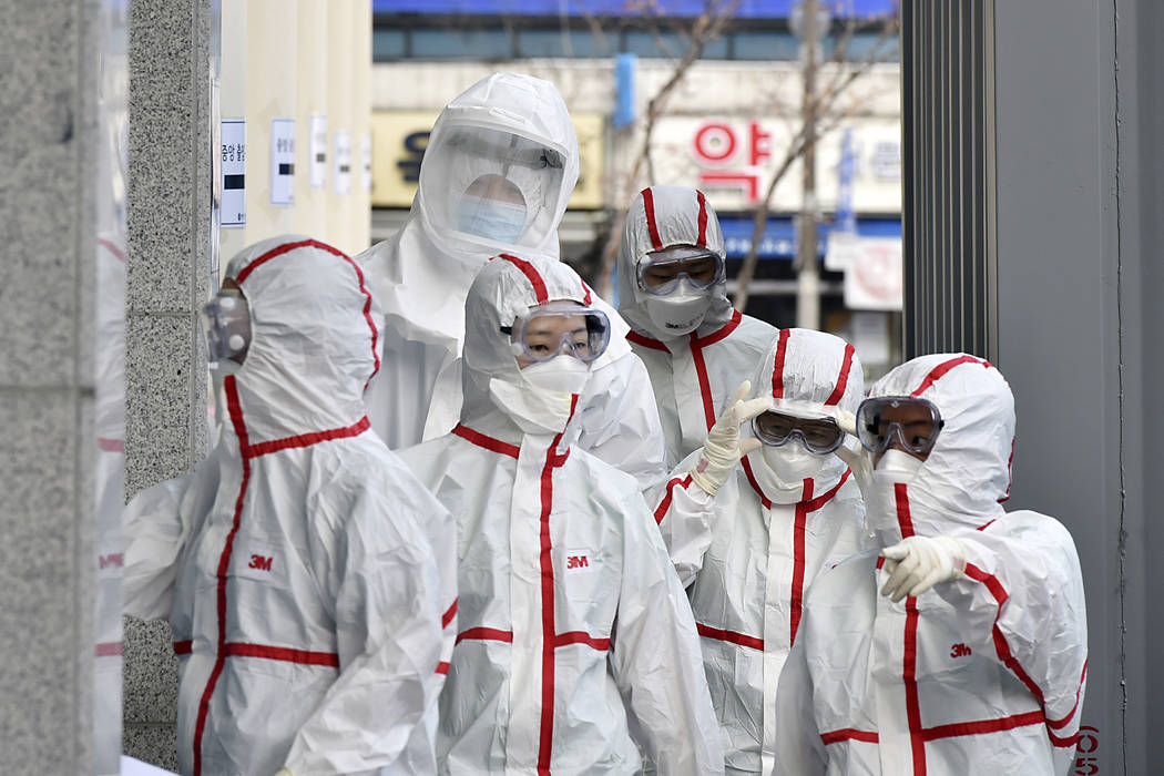 Medical staff members in protective gears arrive for a duty shift at Dongsan Hospital in Daegu, ...