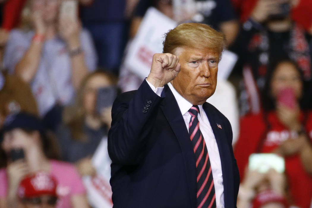 President Donald Trump gestures as he walks offstage after speaking at a campaign rally, Friday ...
