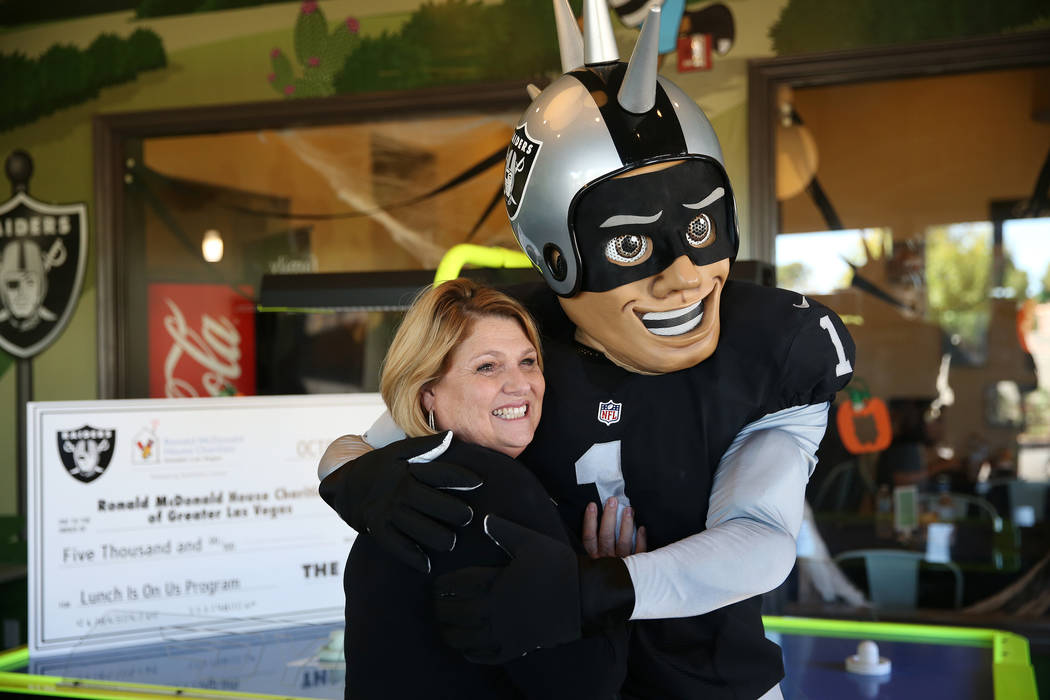 Alyson McCarthy, left, CEO of the Ronald McDonald House, is photographed with Raiders mascot Ra ...