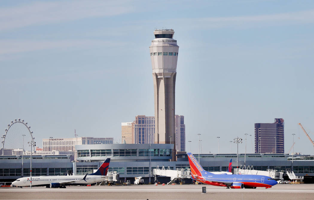 Planes both land and take off at the McCarran International Airport in Las Vegas on Thursday, F ...