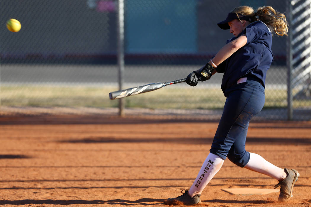 Shadow Ridge's Hailey Morrow, 16, connects with the ball during a softball practice at Shadow R ...
