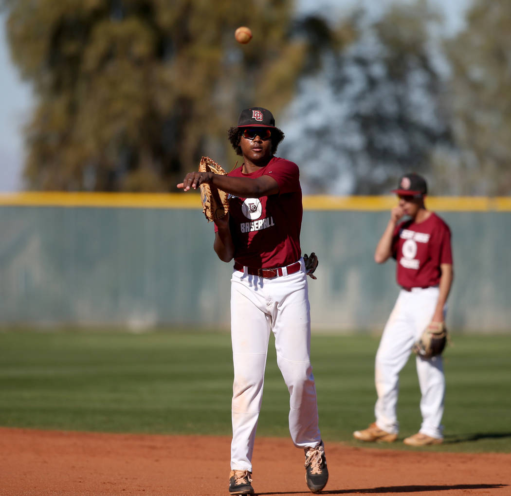 Desert Oasis first baseman Jake Walsh tosses the ball in during batting practice at the school ...