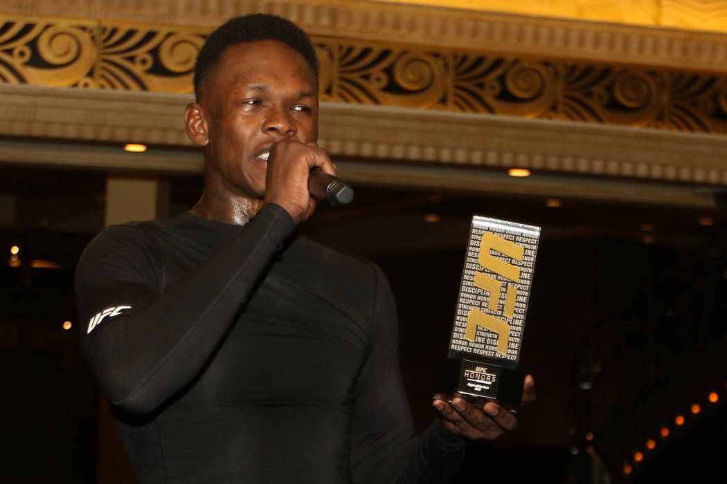 UFC middleweight champion Israel Adesanya accepts an award for UFC Fight of the Year during th ...