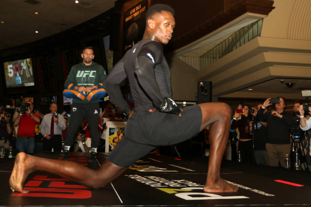 UFC middleweight champion Israel Adesanya stretches during the UFC 248 open workouts at the MGM ...