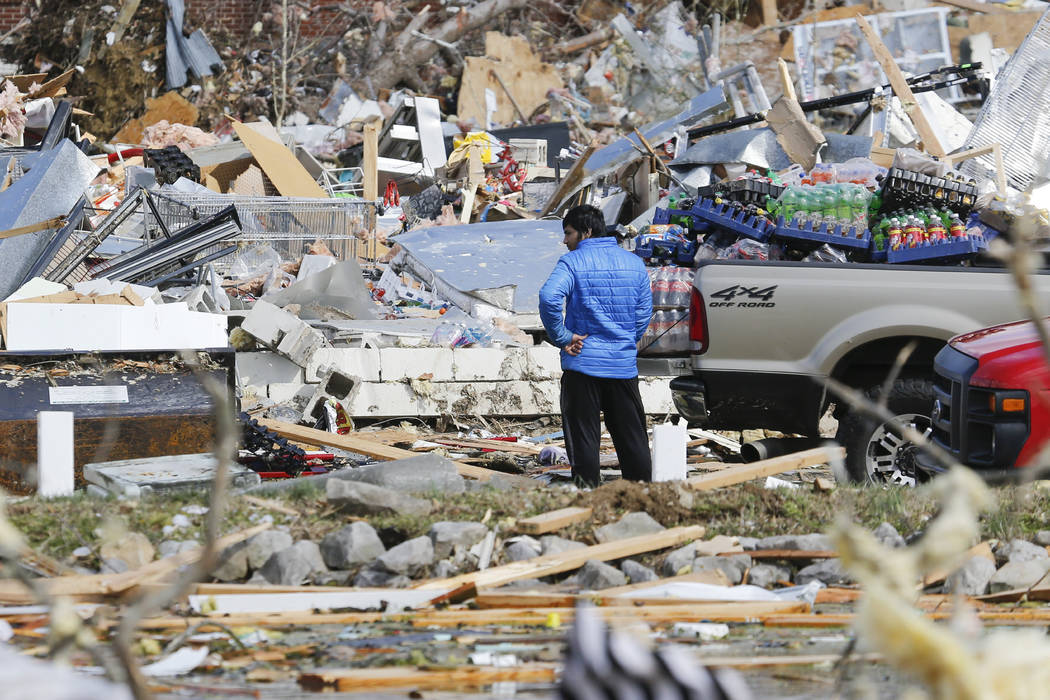 A man looks for items he can salvage from his store Tuesday, March 3, 2020, near Cookeville, Te ...