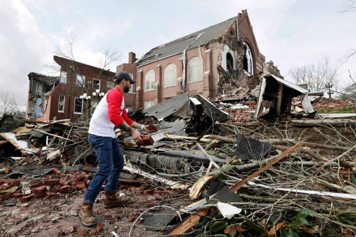 Sumant Joshi helps to clean up rubble at the East End United Methodist Church after it was heav ...