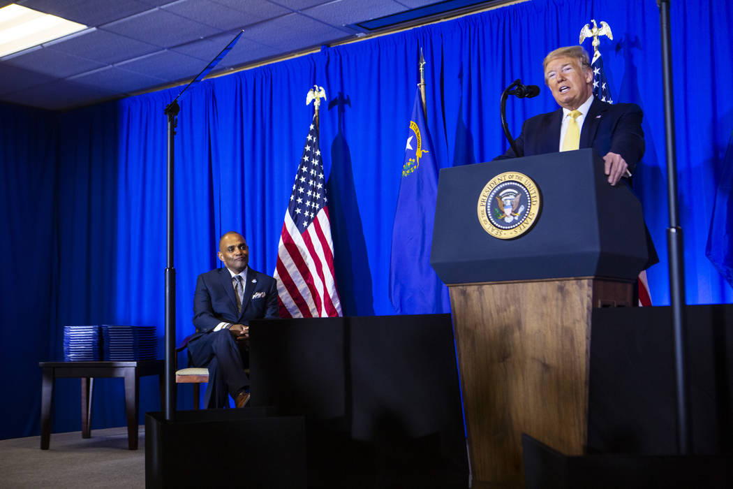 President Donald Trump speaks as Hope for Prisoners CEO Jon Ponder, left, looks on during a gra ...