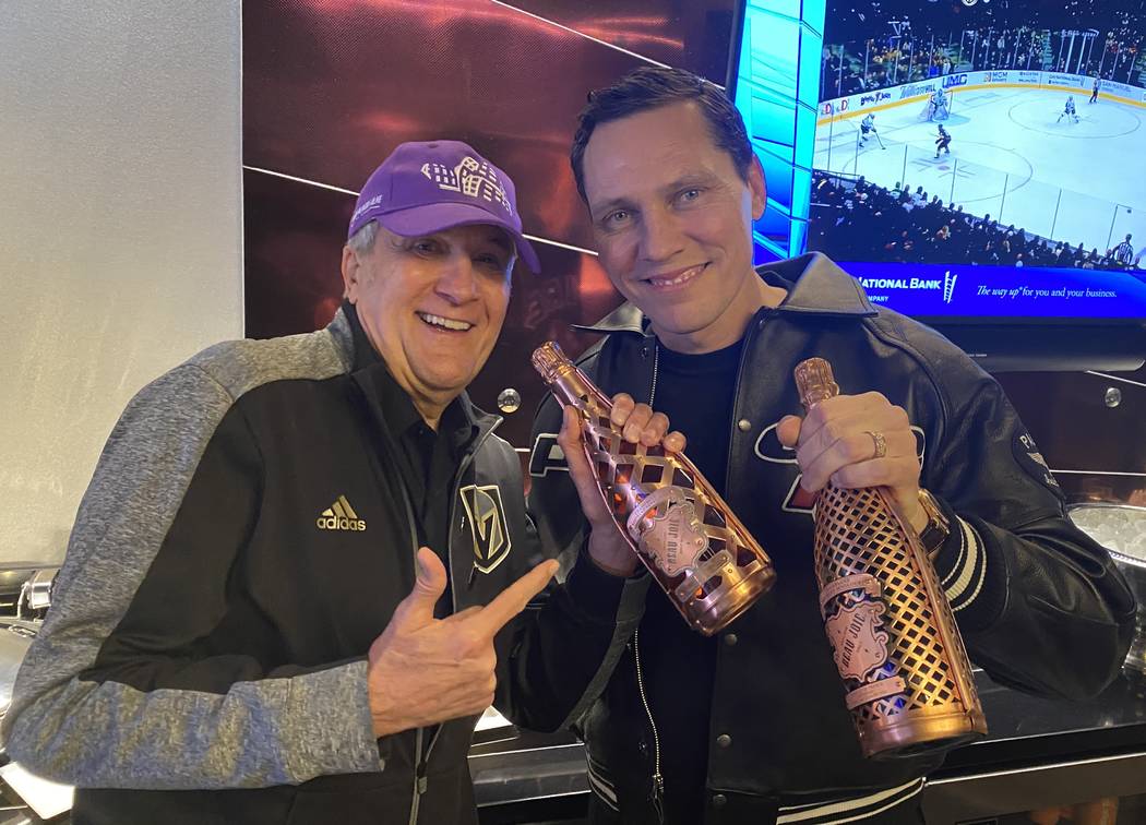 Tiesto and Cleveland Clinic Lou Ruvo Center for Brain Health founder Larry Ruvo hold bottles of ...