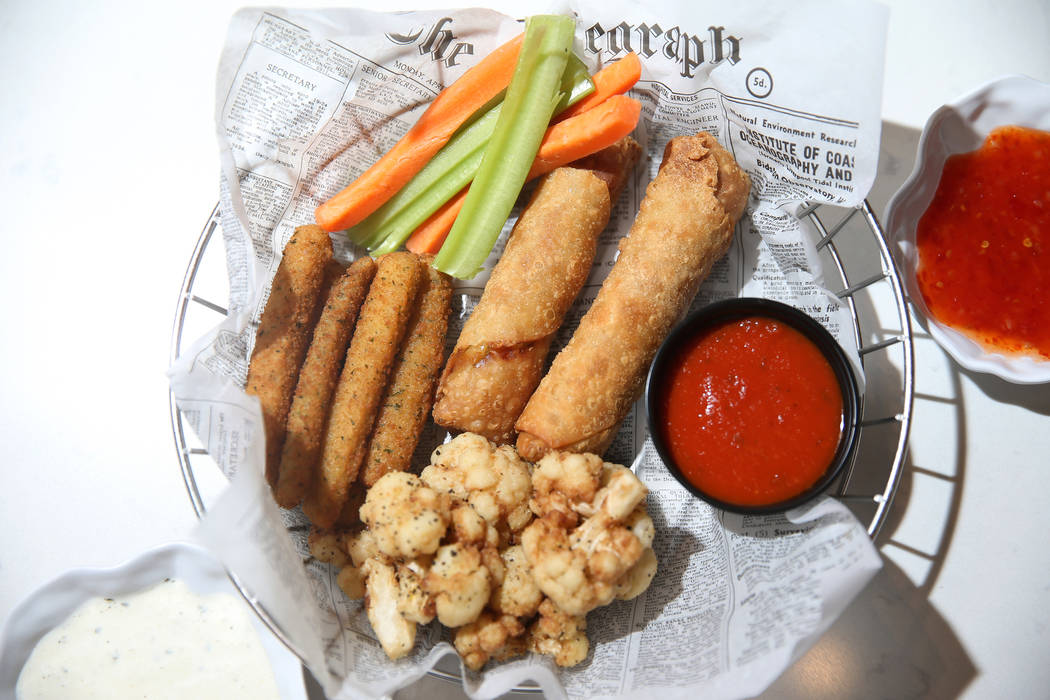 The appetizer platter served with cauliflower, zucchini sticks and chicken egg rolls, at Earl G ...