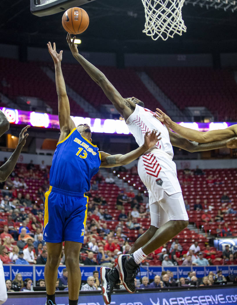 New Mexico Lobos forward Corey Manigault (1, right) touches in a shot over San Jose State Spart ...