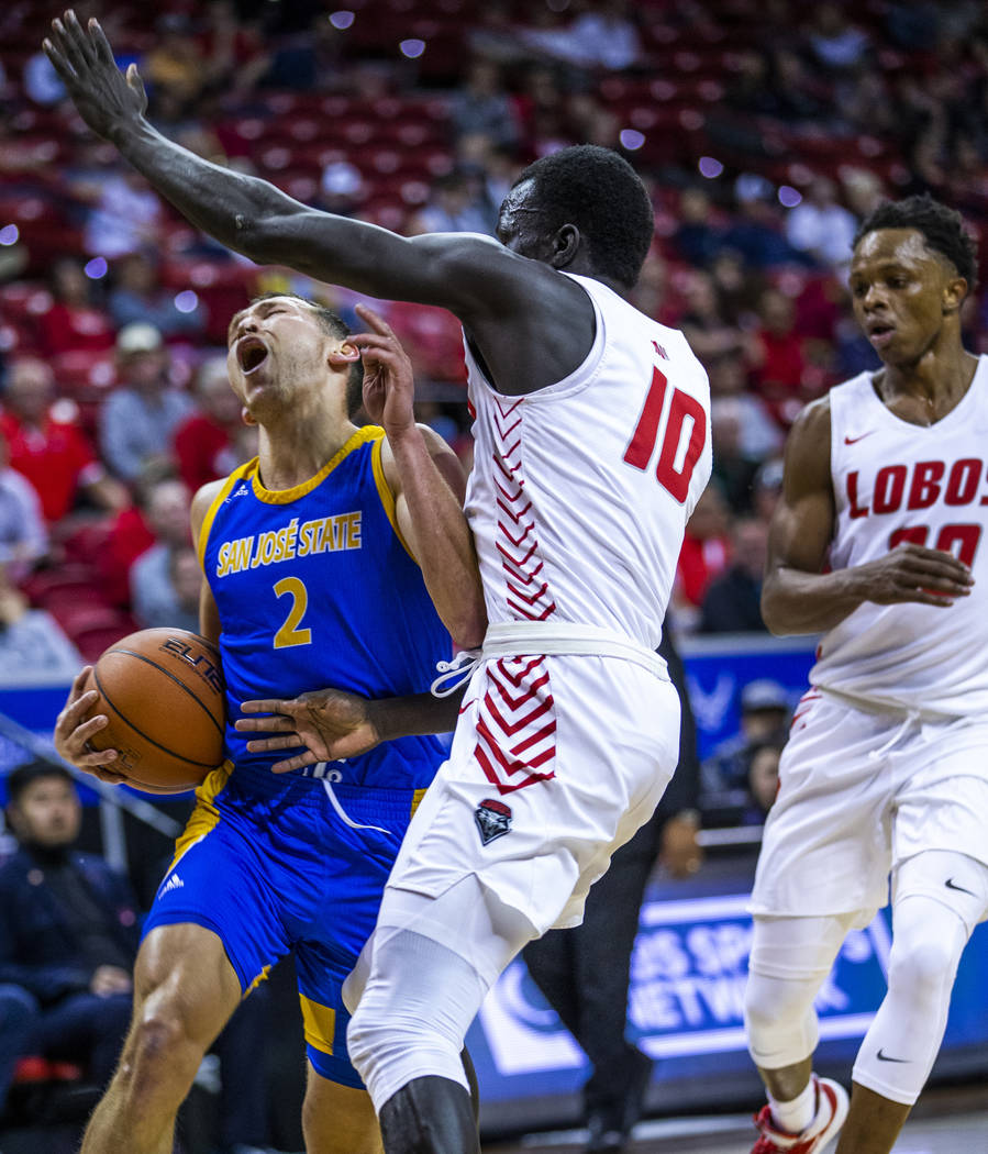 San Jose State Spartans guard Brae Ivey (2, left) takes a charge from New Mexico Lobos guard Ma ...
