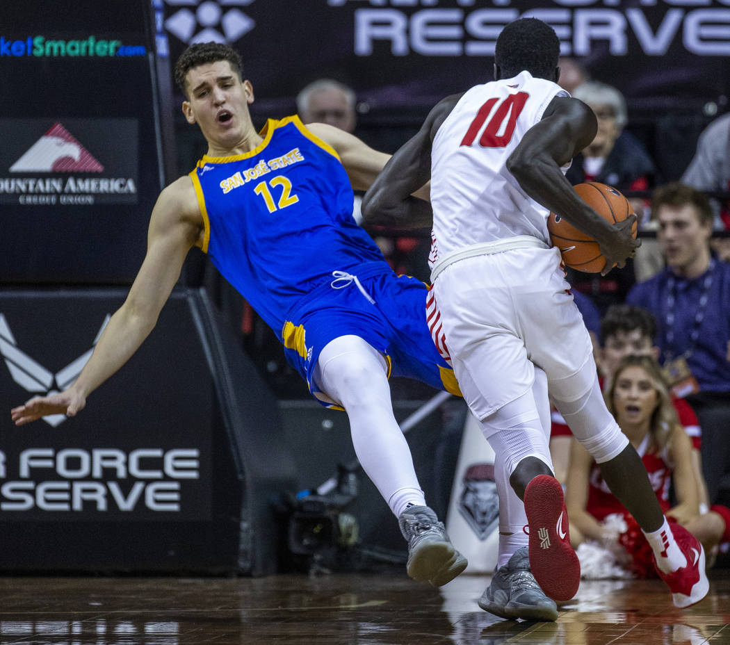 San Jose State Spartans forward Eduardo Lane (12, left) absorbs a charge from New Mexico Lobos ...