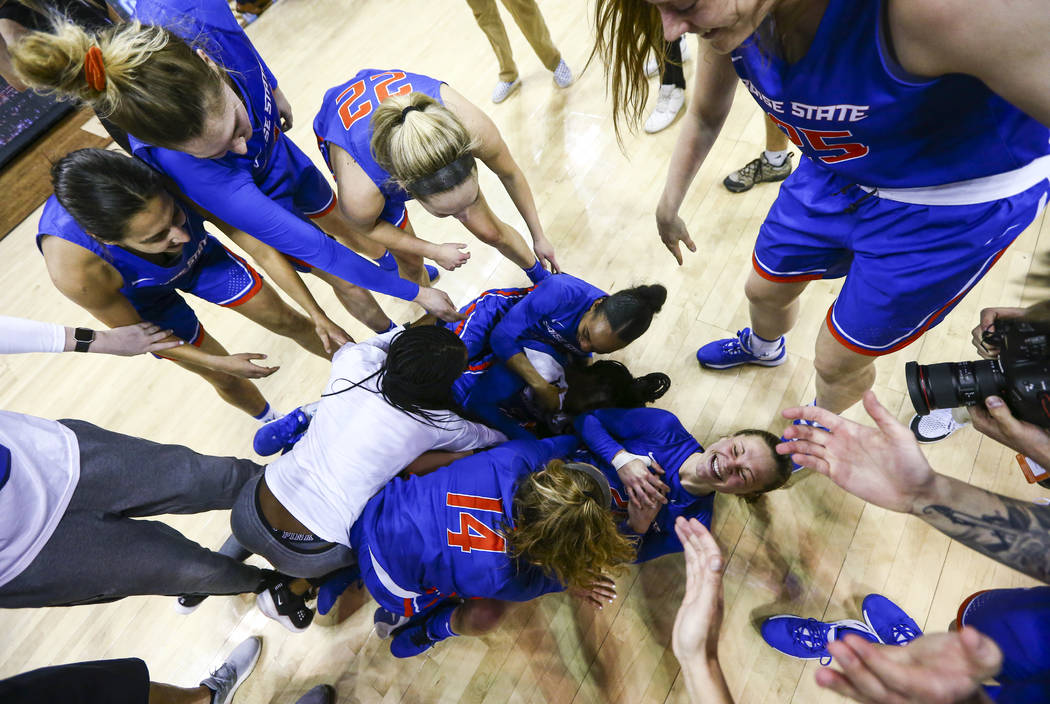 Boise State players celebrate after winning the Mountain West women's championship basketball g ...