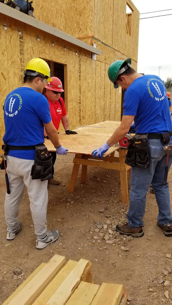 City National Bank colleagues helped cut wood panels for the roof for a Habitat for Humanity La ...