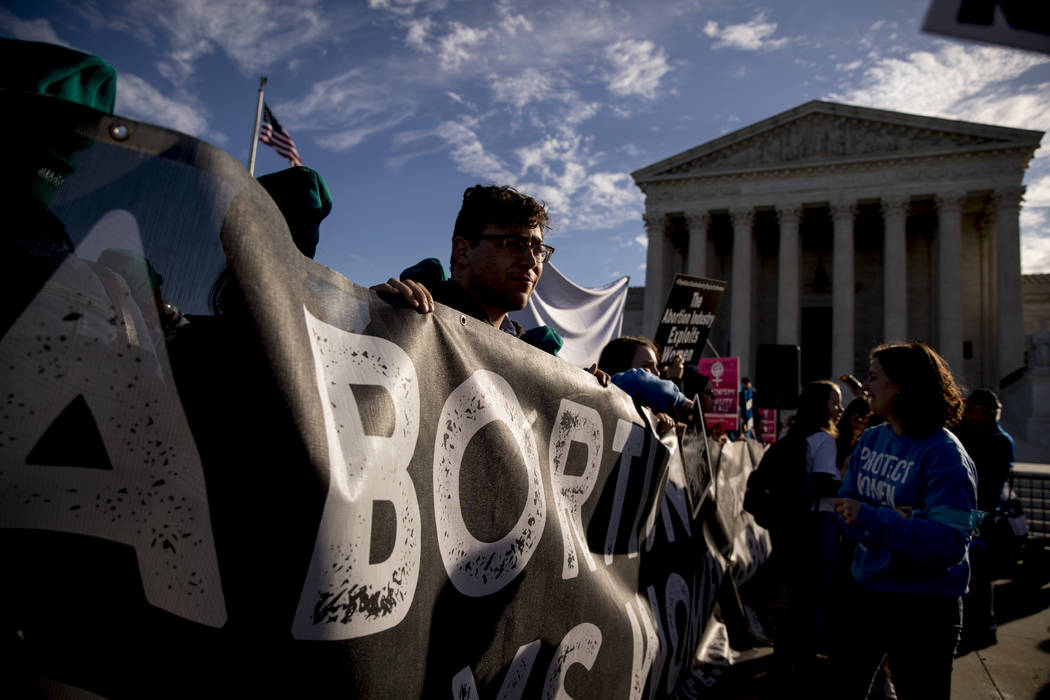Anti-abortion rights demonstrators rally outside the Supreme Court, in Washington, Wednesday, M ...