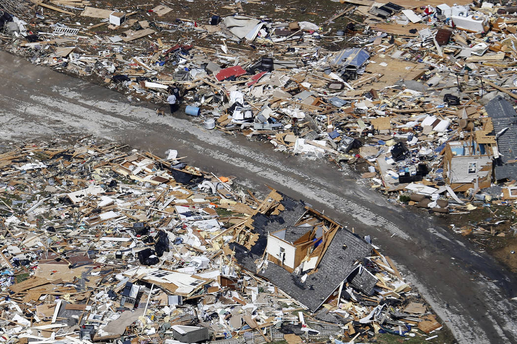 A road separates properties filled with debris Tuesday, March 3, 2020, near Lebanon, Tenn. Torn ...