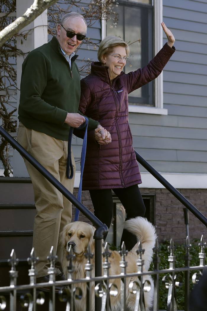 Sen. Elizabeth Warren, D-Mass., with her husband Bruce Mann, and dog Bailey in front, leave her ...