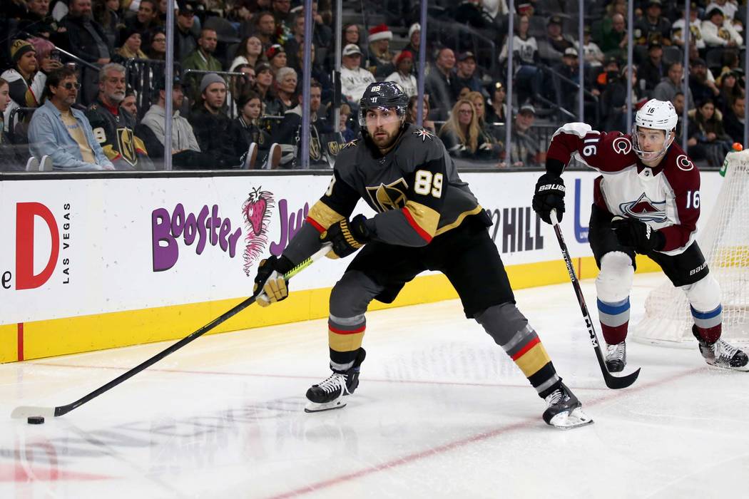 Vegas Golden Knights right wing Alex Tuch (89) moves the puck in front of Colorado Avalanche de ...