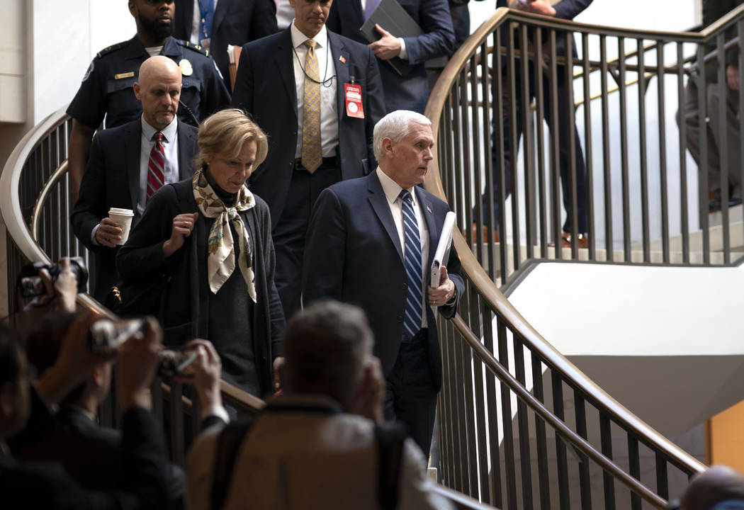 Vice President Mike Pence, center, joined at left by Dr. Deborah Birx, the coronavirus response ...