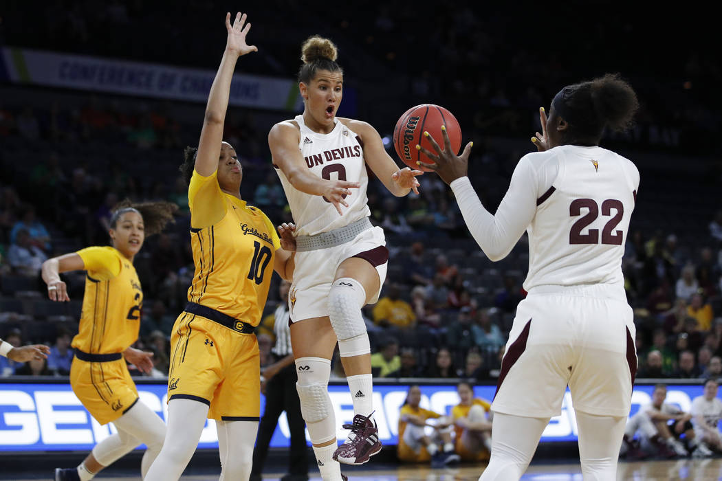 Arizona State's Taya Hanson, center, passes to Eboni Walker (22) during the first half of an NC ...