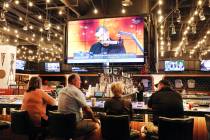 Patrons play video game at the new sportsbook at Park MGM on Friday, March. 6, 2020, in Las Veg ...