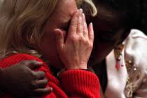 Brigitte Smith, right, comforts Joetta Burke while the prosecution show photos of their childre ...