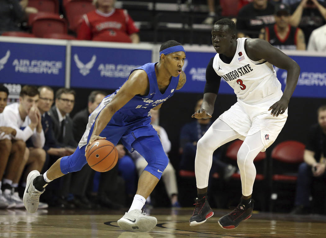 Air Force's Lavelle Scottie drives as San Diego State's Aguek Arop defends during the second ha ...