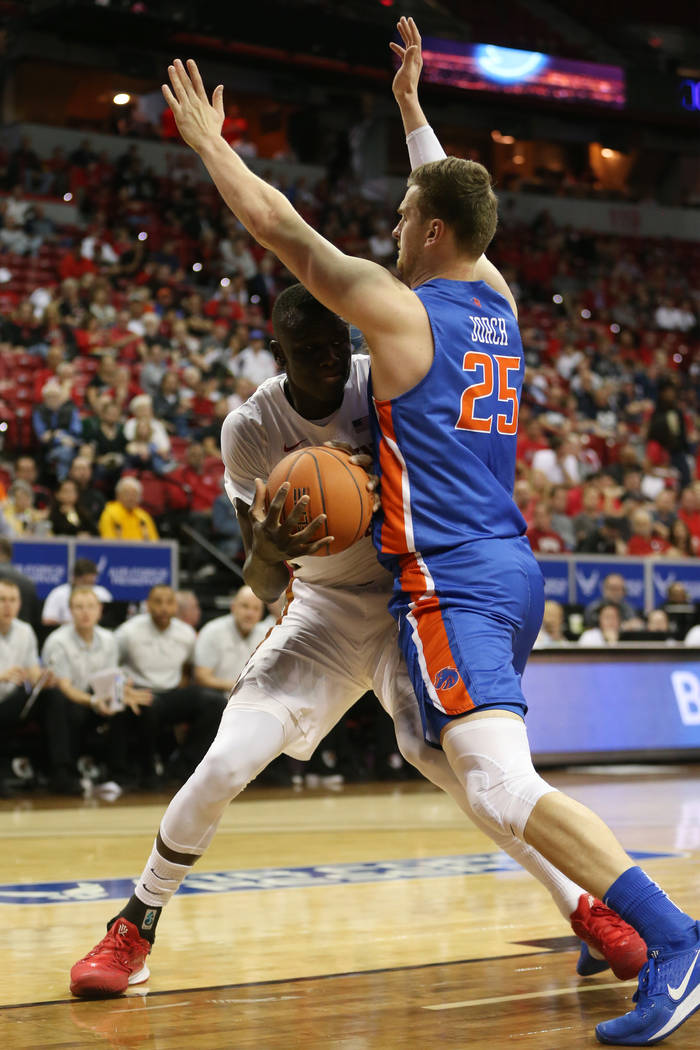 UNLV Rebels forward Cheikh Mbacke Diong (34) is pressured by Boise State Broncos center Robin J ...