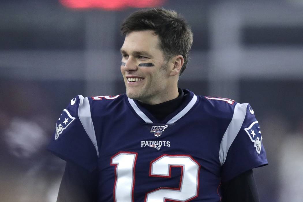 New England Patriots quarterback Tom Brady walks on the field before an NFL wild-card playoff f ...