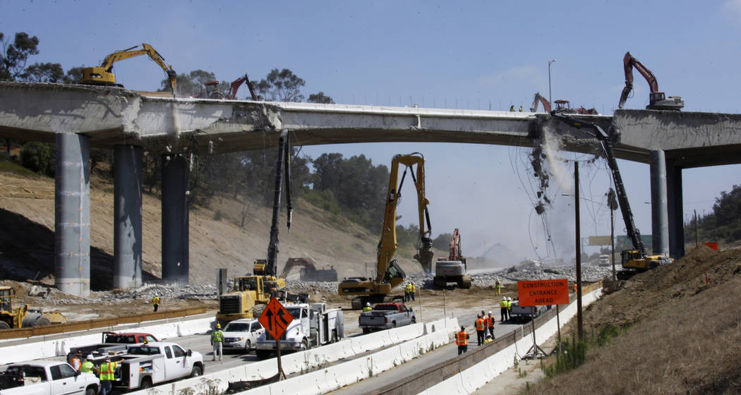 Pneumatic hammers continue the demolition of two lanes of Mulholland Drive bridge over Intersta ...