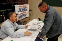 In a Nov. 2, 2017, photo, a recruiter in the shale gas industry, left, speaks with an attendee ...