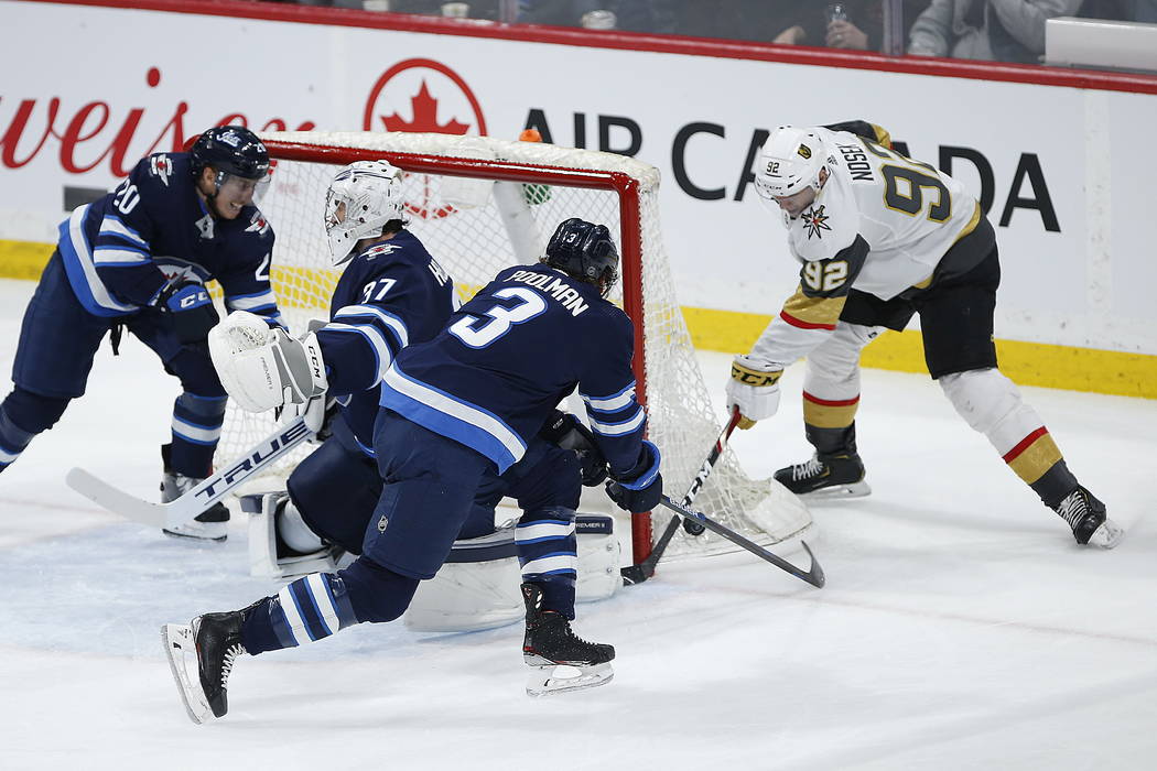 Winnipeg Jets' Cody Eakin (20), Nikolaj Ehlers (27) and Tucker Poolman (3) celebrate Ehlers' go ...