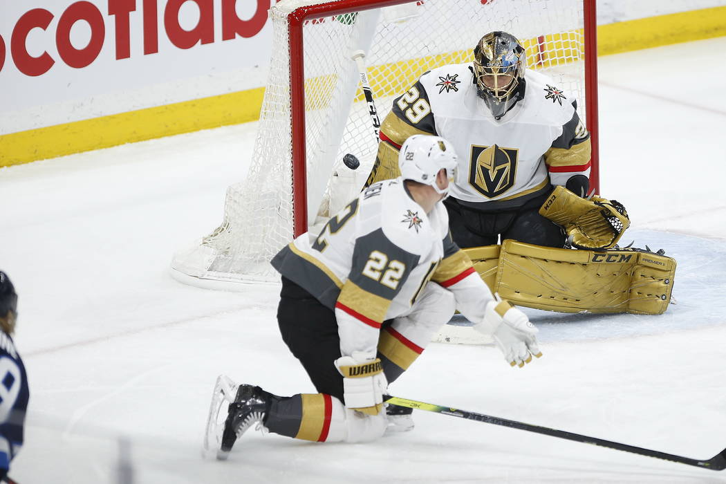 A shot by Winnipeg Jets' Patrik Laine, just out of frame at left, gets past Vegas Golden Knight ...