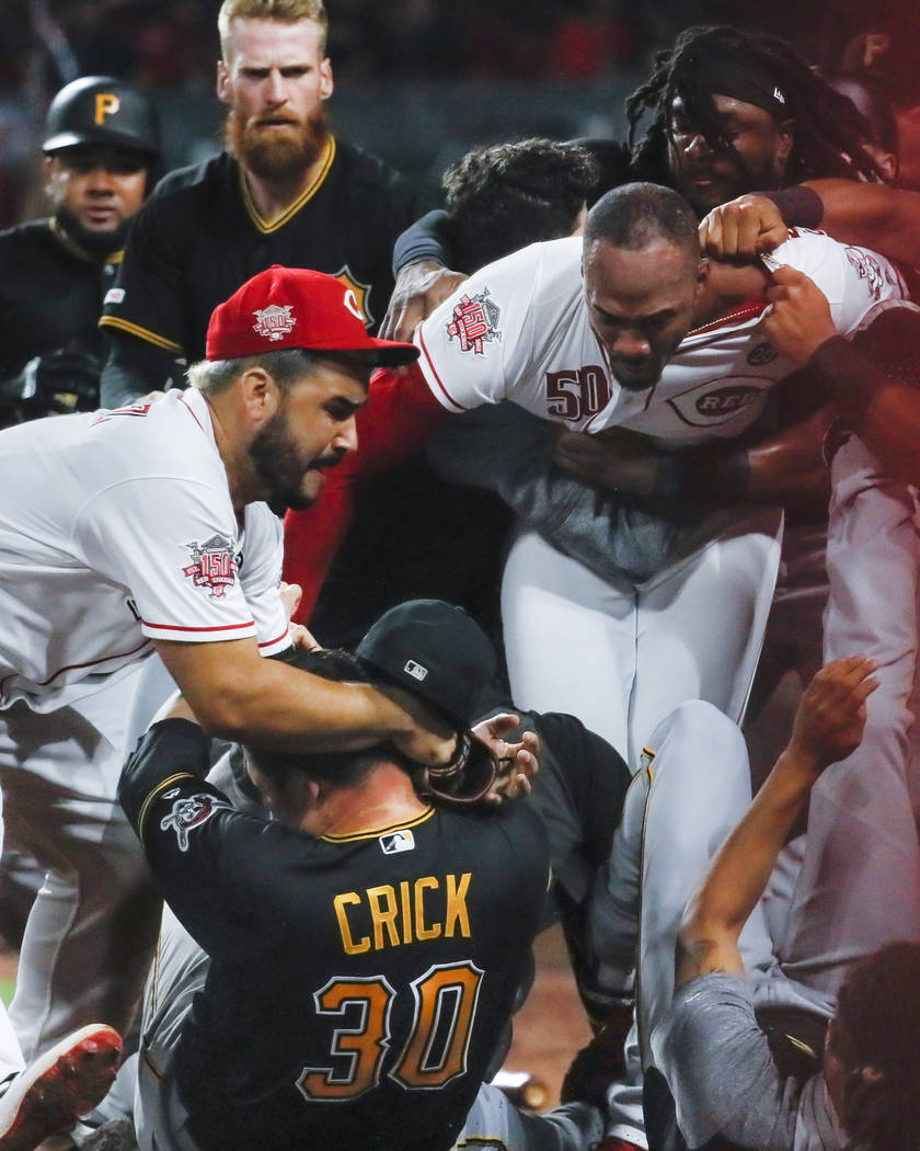 Pittsburgh Pirates relief pitcher Kyle Crick (30), Cincinnati Reds third baseman Eugenio Suarez ...