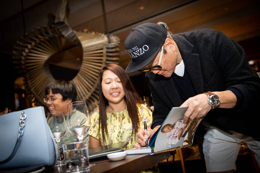 Masaharu Morimoto signs a book for guests at Manzo in Eataly Las Vegas (Erik Kabik/Kabik Photo ...