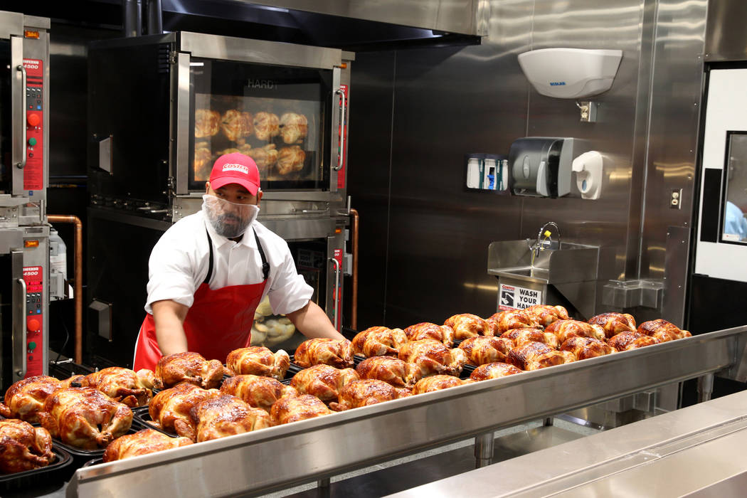 Rotisserie chicken is packaged at the grand opening of Costco near the intersection of St. Rose ...