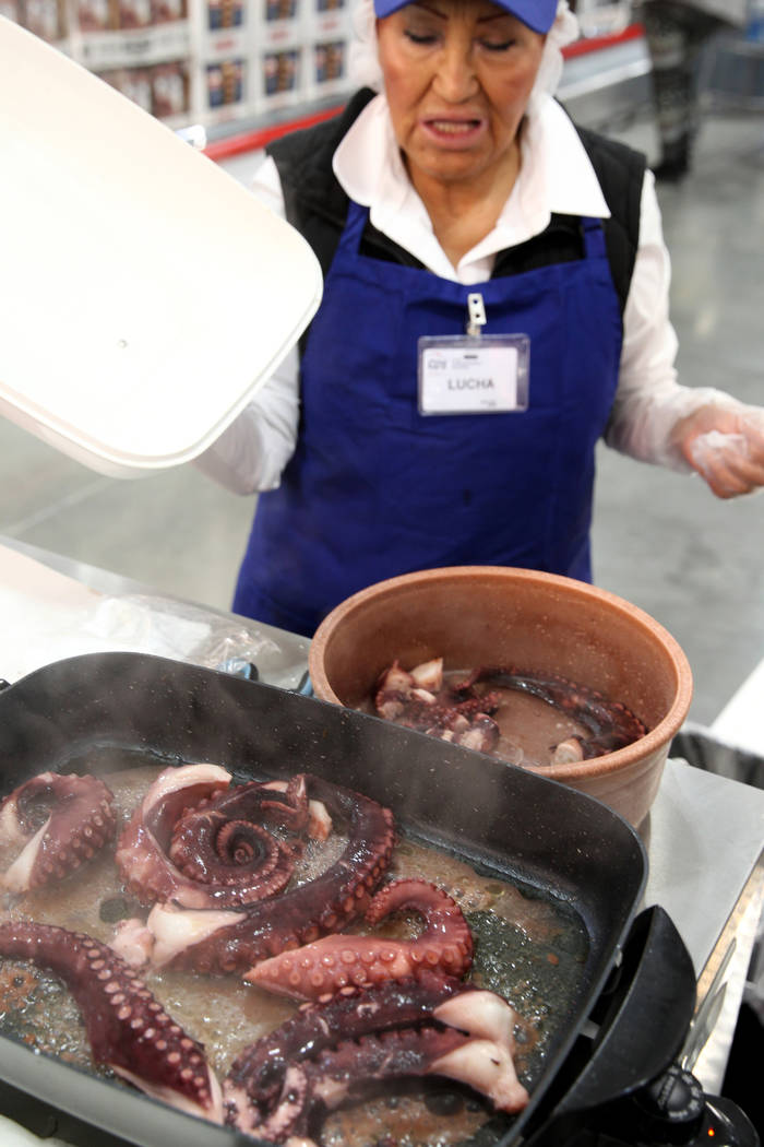 Lucha Parnham serves up free samples of cooked octopus at the grand opening of Costco near the ...