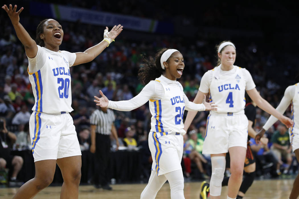 UCLA's Charisma Osborne, left, Japreece Dean, center, and Lindsey Corsaro celebrate after a pla ...