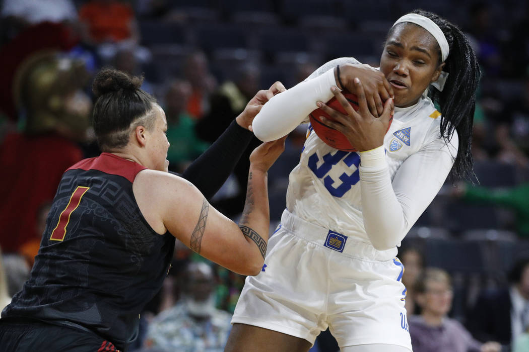 UCLA's Lauryn Miller (33) grabs a rebound over Southern California's Kayla Overbeck (1) during ...
