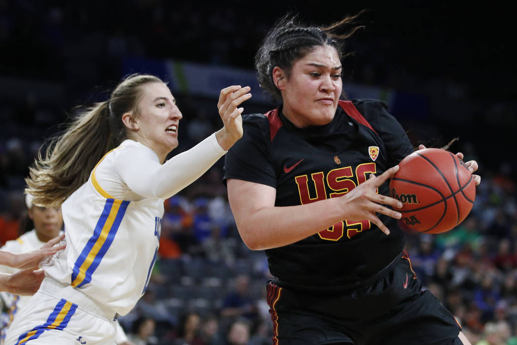 Southern California's Alissa Pili (35) drives around UCLA's Chantel Horvat (0) during the first ...