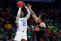 UCLA's Michaela Onyenwere (21) shoots over Southern California's Kayla Overbeck (1) during the ...
