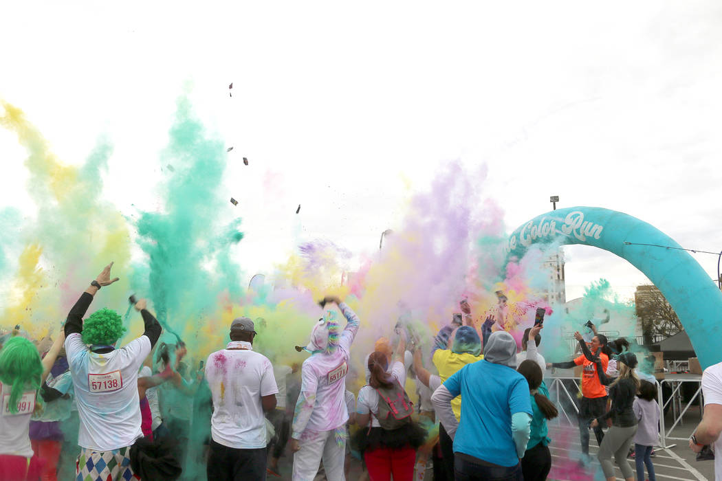 Runners gather at the end of the Color Run for one of many color throws. (Anton)