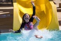 Summerlin resident Erika Harrison, 9, takes a turn on a water slide at the outdoor water park a ...
