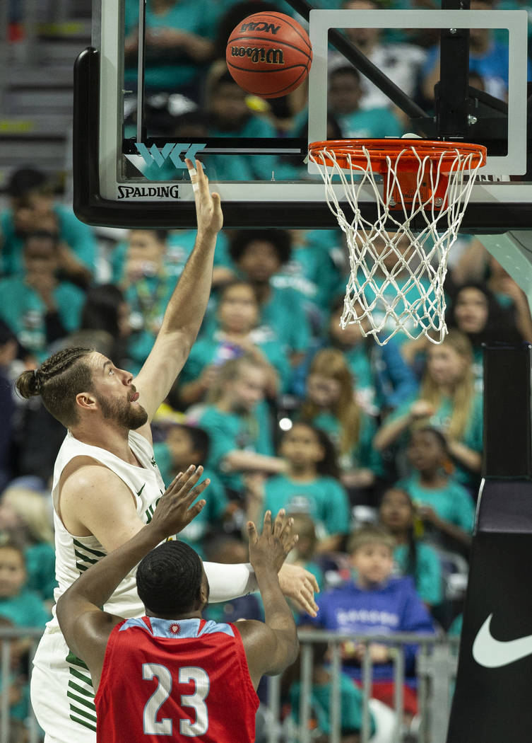 San Francisco Dons center Jimbo Lull (5) shoots over Loyola Marymount Lions forward Jordan Bell ...