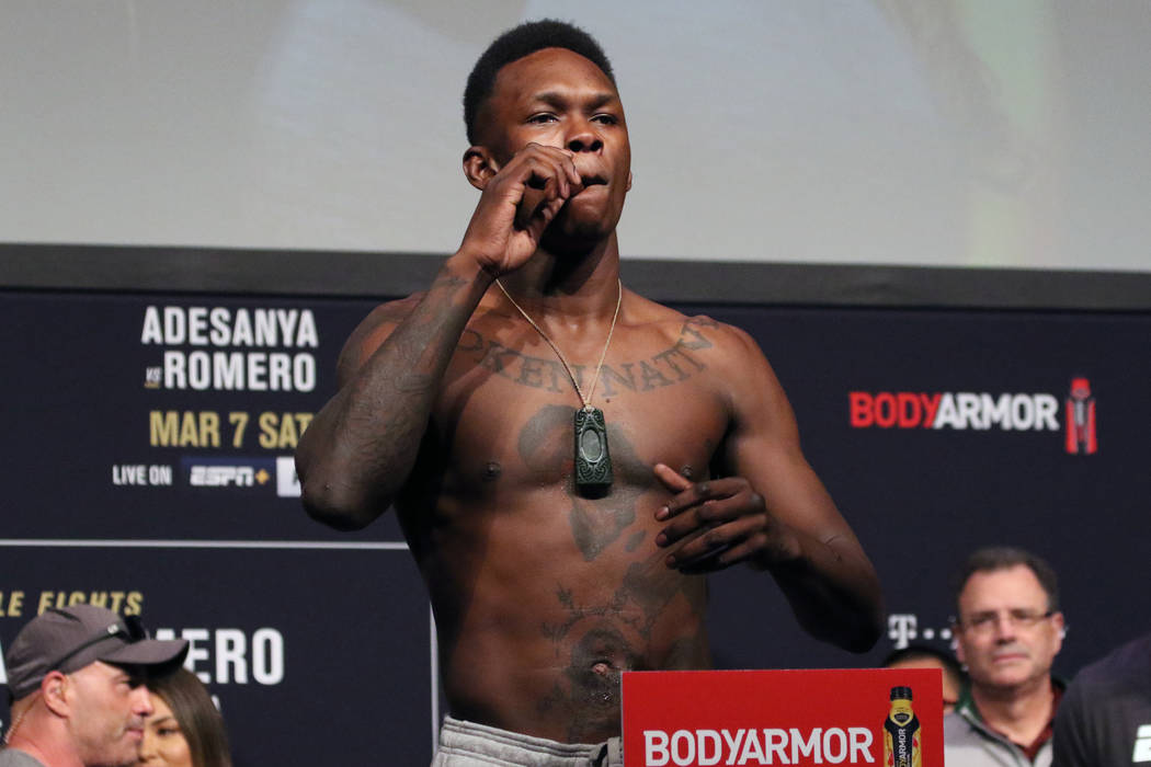 UFC middleweight champion Israel Adesanya poses with a cigar on the scale during the UFC 248 ce ...
