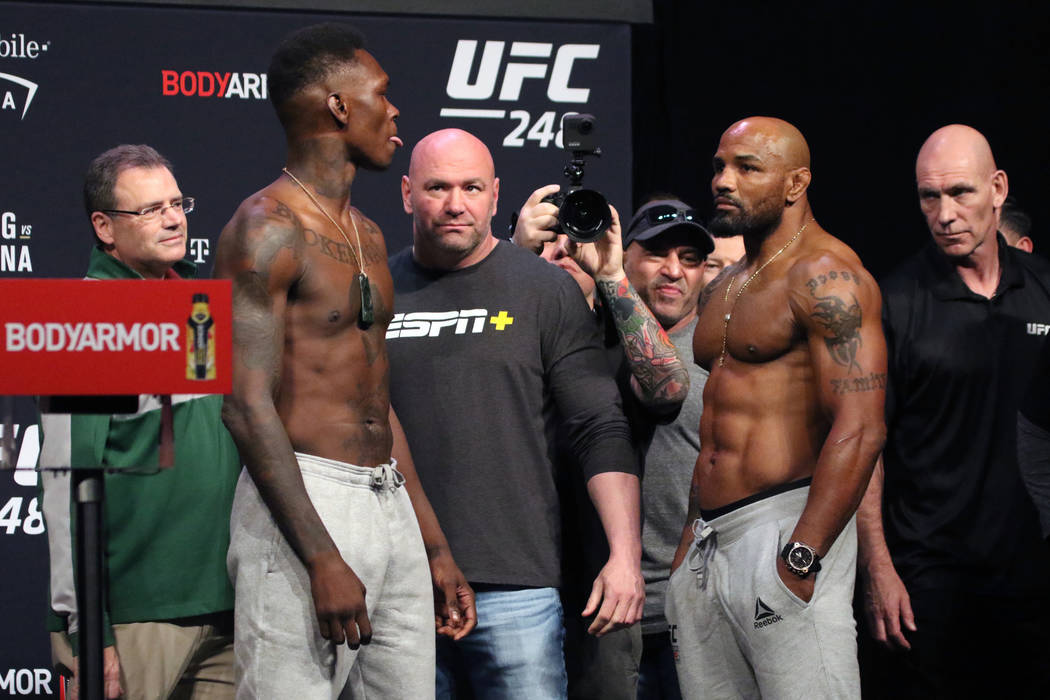 UFC middleweight champion Israel Adesanya, left, faces off against title challenger, Yoel Romer ...